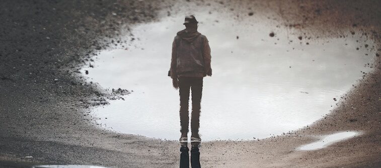 Man's Reflection in a Puddle