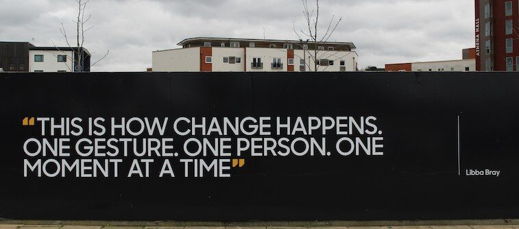 Quote on wall, "This is how change happens.One gesture. One person. One moment at a time."