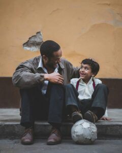 Mentor and Child with a Soccer Ball